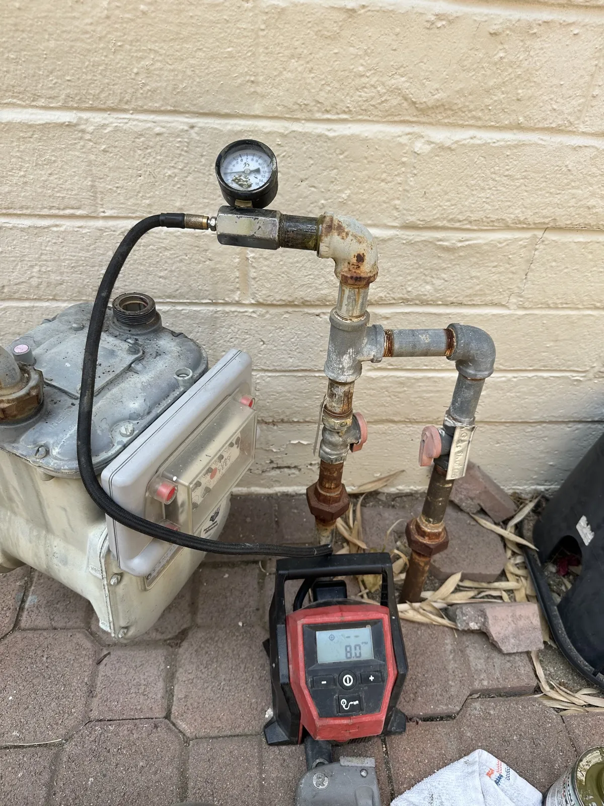 Gas line pressure testing at the meter with gauge and manometer